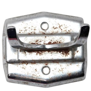 May include: A silver metal hook with a rounded top and two holes. The hook is rusty and has a worn finish.