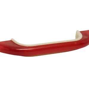 May include: Red plastic car bumper with a white trim. The bumper is curved and has a smooth surface.