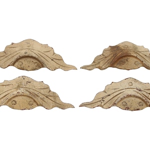 May include: Set of four antique-style, ornate, cream-colored, wooden cabinet pulls with a leaf design.