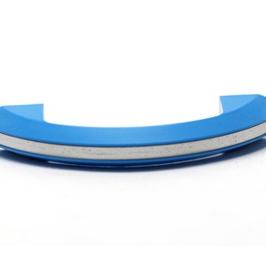 May include: A blue curved cabinet handle with a silver trim.