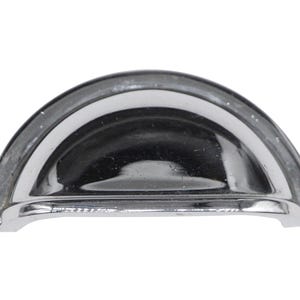 May include: A shiny, silver, cup-shaped cabinet knob with a smooth, rounded surface.