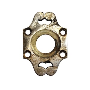 May include: A silver-toned metal door knob with a decorative design and four screw holes.