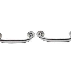 May include: Two silver metal cabinet door handles with rounded edges and a smooth finish.