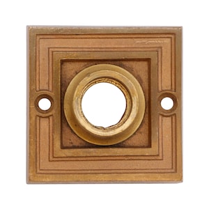 May include: A square brass door plate with a decorative border and a round hole in the center.