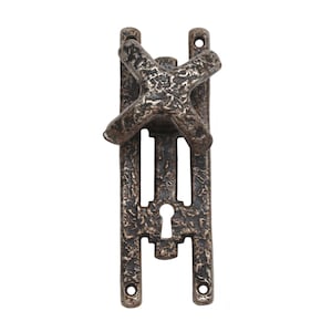May include: A rustic, antique-style door handle with a keyhole and a decorative cross-shaped knob. The handle is made of metal and has a dark brown finish.
