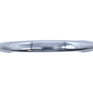 May include: A shiny, silver, curved cabinet door handle.