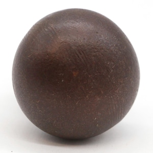 May include: A dark brown, smooth, round ball made of clay.