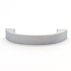May include: A silver metal ring with a rounded, slightly curved shape. The ring is smooth and has a brushed finish.