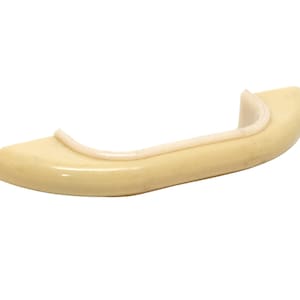 May include: A cream-colored plastic handle with a slightly rounded shape. The handle has a smooth, glossy finish.