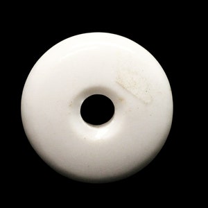 May include: White ceramic button with a round hole in the center.