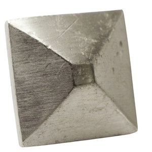 May include: A square, silver-toned metal cabinet knob with a pyramidal center. The knob has a brushed metal finish and a slightly worn appearance, suggesting a vintage or industrial aesthetic. The knob is isolated on a white background.