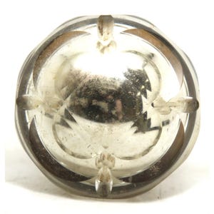 May include: A clear, vintage glass bowl with a decorative design. The bowl has a circular shape with a detailed pattern around the rim and a textured interior. The glass has a slightly aged appearance.
