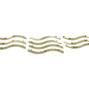 May include: Set of six gold-toned metal cabinet pulls with a wavy design. Each pull has a slightly different curve.