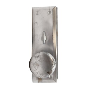 May include: A silver door knob with a round handle and a keyhole. The knob is attached to a silver rectangular plate.
