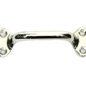May include: A polished chrome-finished pull handle with a curved bar and oval mounting plates. Each plate has two screw holes. The handle is designed for cabinets, drawers, or doors.