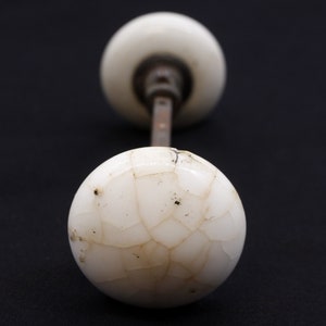 Pair of White Ceramic Door Knobs with Black Cast Iron Shanks