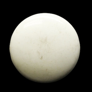 May include: A white ceramic sphere with a slightly textured surface.