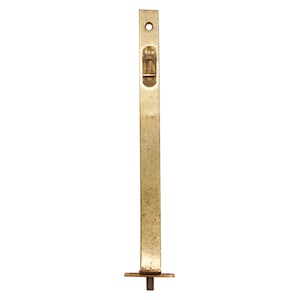 May include: A gold-toned metal door latch with a rectangular shape and a small, rectangular latch mechanism. The latch is attached to a square base.