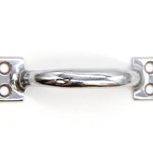 May include: A silver-toned metal door handle with a rounded shape and two screw holes on each side.