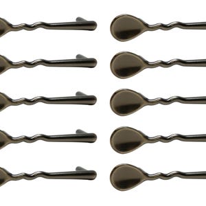 May include: Ten silver-toned metal drawer pulls with a wavy design and a rounded, spoon-shaped end.