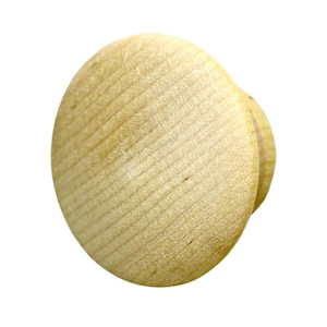 May include: A light-colored, round wooden knob with a flat front and a smaller, rounded back. The wood grain is visible, running diagonally across the surface. The knob is likely for furniture or cabinetry.