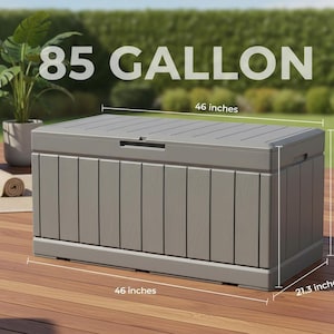 May include: A gray outdoor storage chest with a capacity of 85 gallons. The chest is 46 inches long and 21.3 inches high. It has a hinged lid and vertical paneling on the sides. The text "85 GALLON" is displayed on the top.