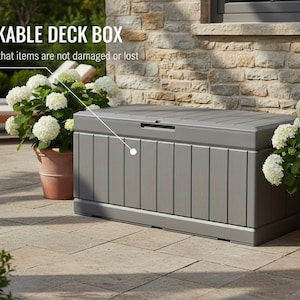May include: A gray lockable deck box with vertical paneling, designed for outdoor storage. The box is on a stone patio, with white flowers in terracotta pots nearby. The text "LOCKABLE DECK BOX" is visible.