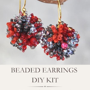 May include: A pair of spherical beaded earrings featuring a mix of red, black, and silver beads suspended from gold-toned hooks. Below the earrings, the text reads: BEADED EARRINGS DIY KIT Materials + Tutorial. The design is dense and textured.
