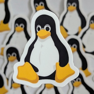 May include: A collection of die-cut stickers featuring the Linux mascot, Tux the penguin. Each sticker displays a black and white penguin with a yellow beak and yellow webbed feet, sitting in a forward-facing position against a white background.