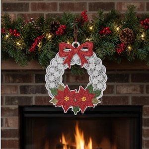 May include: A white lace Christmas wreath with a red bow and poinsettias. The wreath is hanging in front of a brick fireplace, with a garland of greenery, berries, and lights above.