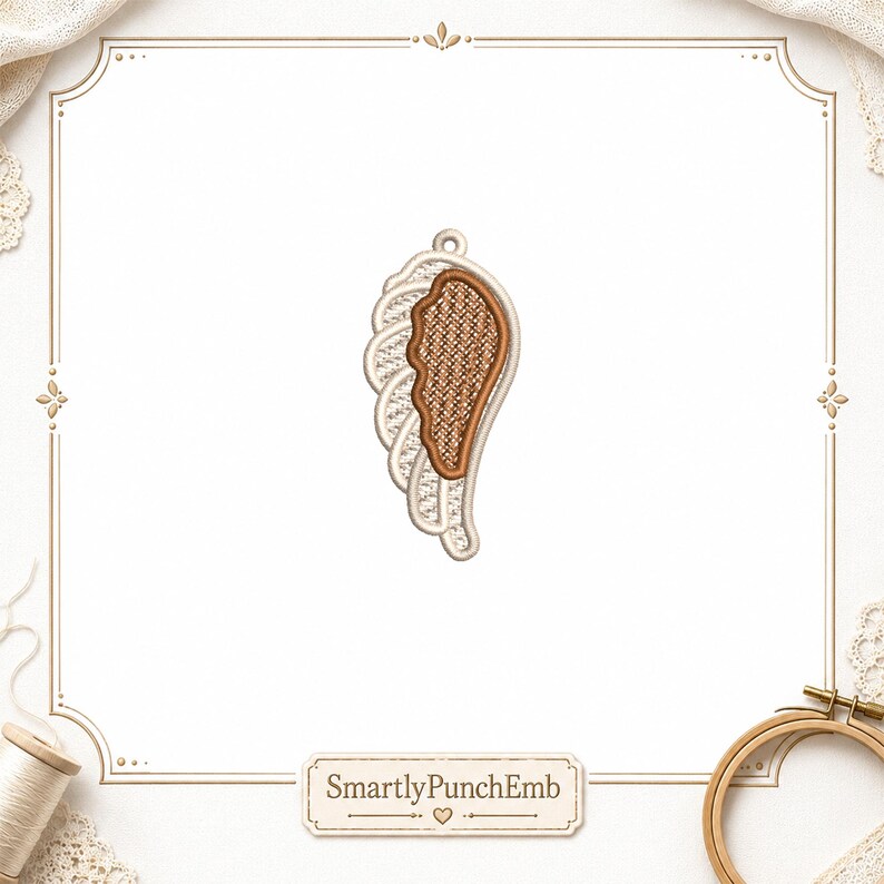 May include: Embroidered wing design with a textured brown center, outlined in tan and white. The wing has a loop at the top for hanging. The design is set against a white background with a decorative border. The text "SmartlyPunchEmb" is at the bottom.