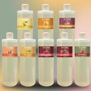 May include: A collection of clear plastic bottles with white caps, each labeled with a different fruit flavor. Flavors include lemon, orange, passionfruit, peach, pineapple, pomegranate, raspberry, and strawberry. The labels feature the brand name "Eva Paul".