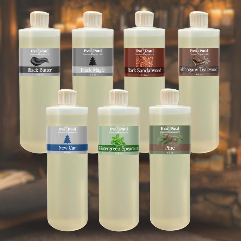 May include: A collection of clear bottles with white caps and labels. The labels display the "Eva Paul" brand and fragrance names like "Black Butter," "Black Magic," "Dark Sandalwood," "Mahogany Teakwood," "New Car," "Wintergreen Spearmint," and "Pine."