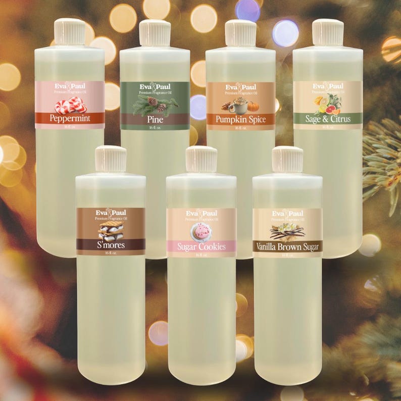 May include: A collection of clear plastic bottles with white caps, each labeled with a different fragrance name. Scents include Peppermint, Pine, Pumpkin Spice, Sage & Citrus, S'mores, Sugar Cookies, and Vanilla Brown Sugar. The brand name "Eva Paul" is visible on each label.