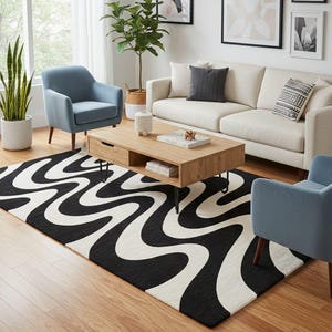 May include: A living room scene featuring a black and white patterned rug with a wavy design. The room includes a light-colored sofa, two blue armchairs, a wooden coffee table, and framed artwork on the wall. Plants add a touch of nature.