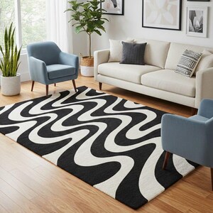May include: A black and white area rug with a wavy pattern dominates the living room. Two light blue armchairs and a cream-colored sofa complement the rug. Artwork and plants add to the room's decor.