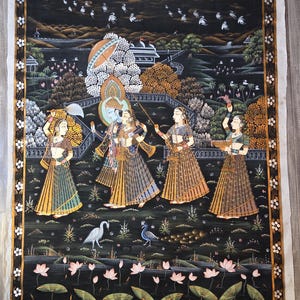 May include: An Indian miniature painting on a black background, depicting a scene with figures in traditional attire. The artwork features a detailed landscape with trees, birds, and lotus flowers, framed by a decorative border.