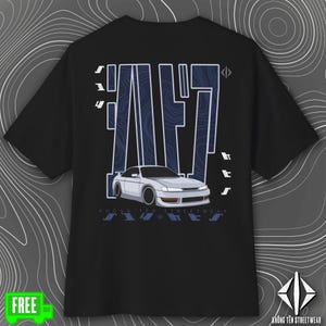 May include: Black t-shirt featuring a white car graphic with blue accents and text. The design includes the word "FAST" in a stylized font, along with additional text and a logo at the bottom. The shirt is from Khong Ten Streetwear.