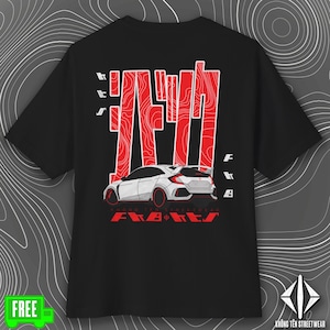 May include: Black t-shirt with a white car graphic and red Japanese text. The design includes the text "F.A.B.E.T.S" and "KHÔNG TÊN STREETWEAR". The shirt has a crew neck and short sleeves.