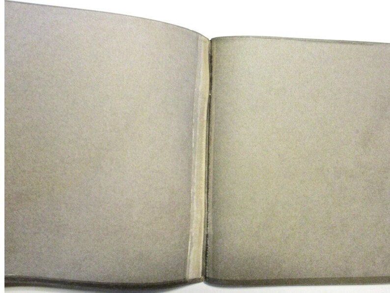 Inside cover of pamphlet.  It appears to have a broken binding or become unglued.  However, that is all part of the graphic design.  The pamphlet is in very good condition.