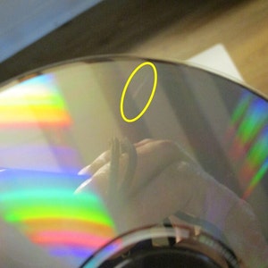 Lone mark on one of the CDs is circled in yellow.  These CDs had been in a multi disc player and not handled much until removed and placed in their sleeves.  These CDs are in good condition but have not been played since 2003.