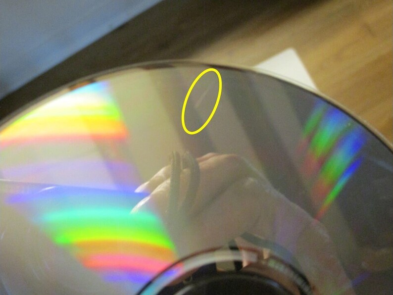 Lone mark on one of the CDs is circled in yellow.  These CDs had been in a multi disc player and not handled much until removed and placed in their sleeves.  These CDs are in good condition but have not been played since 2003.