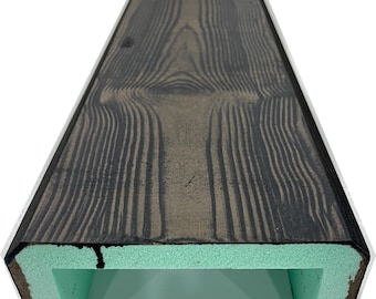 May include: A dark brown, rectangular faux wood beam with a light green interior. The wood grain pattern is visible on the top surface. The beam has a hollow, open bottom.