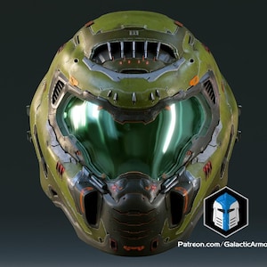 May include: An olive green and orange helmet with a reflective green visor. The helmet features a complex design with vents and intricate detailing. The Galactic Armory logo and website are visible on the lower right.