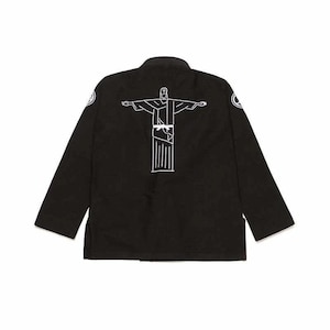 May include: Black martial arts uniform with a white outline of the Christ the Redeemer statue on the back. The uniform has long sleeves and a mandarin collar. Two circular patches are on the sleeves.