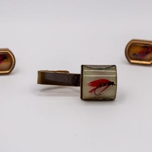 May include: A set of three ceramic vases in varying heights. The vases are white with a textured, ridged design. The tallest vase is approximately 10 inches tall, the medium vase is 8 inches, and the smallest is 6 inches.