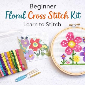 May include: A beginner's floral cross stitch kit, with the text "Beginner Floral Cross Stitch Kit Learn to Stitch". The kit includes an embroidery hoop, threads, needles, and a cross-stitch pattern with floral designs.
