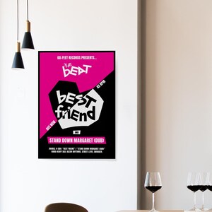 May include: A framed poster with a black border, featuring a pink and black design with the words "THE BEAT BEST FRIEND" in white. The poster also includes the text "STAND DOWN MARGARET (DUB)" and "45 RPM".