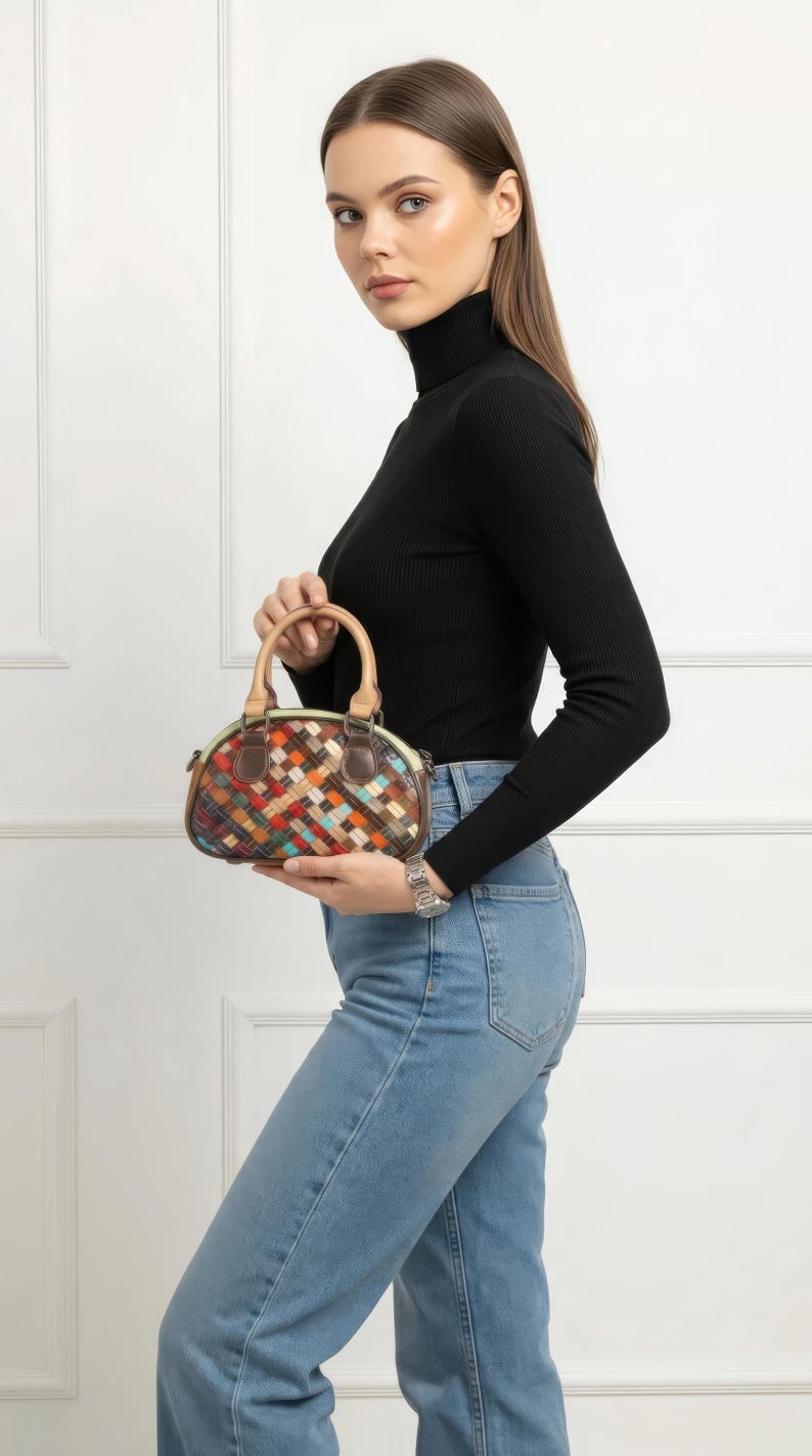 May include: A small, colorful handbag with a woven pattern. The bag features a rounded shape, a top handle, and a shoulder strap. The color palette includes brown, orange, blue, and green. The bag is made of leather.