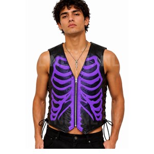 May include: Black leather vest with a purple skeleton design. The vest has a V-neck, a front zipper, and lace-up sides. The skeleton design is painted in a vibrant purple color. The vest is sleeveless and appears to be made of leather.